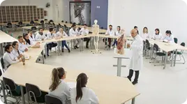 sala de aula com alunos sentados e um professor